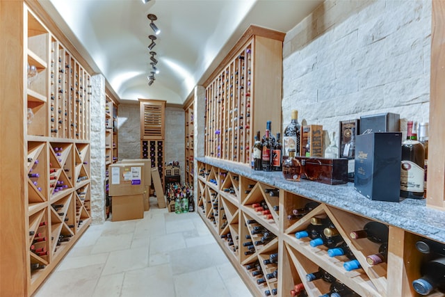 wine room featuring track lighting