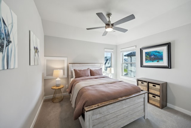 carpeted bedroom with baseboards and a ceiling fan