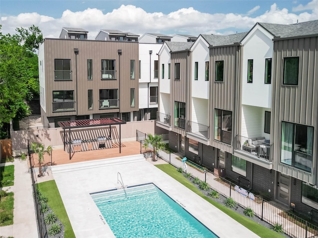 community pool featuring fence and a patio