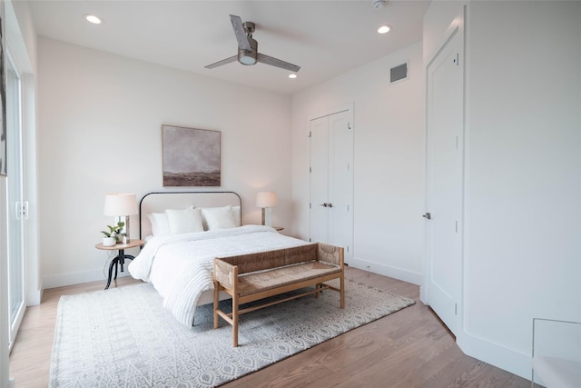 bedroom with light wood-type flooring, recessed lighting, baseboards, and a ceiling fan