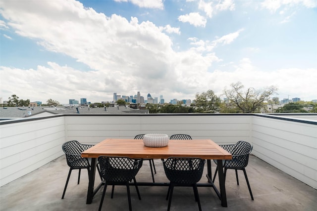 balcony with a skyline view and outdoor dining area