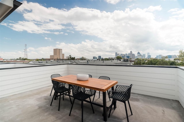 balcony with a view of skyline and outdoor dining space