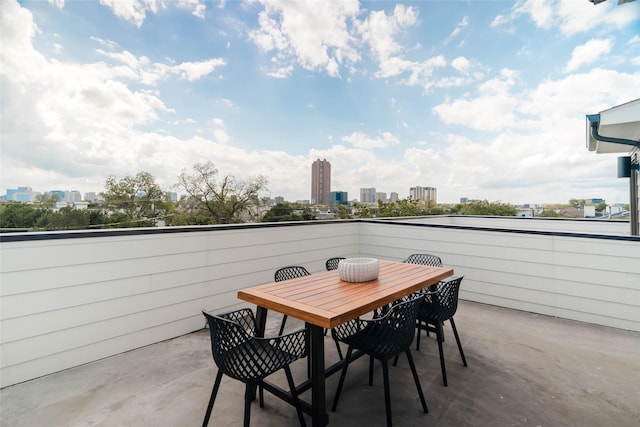 view of patio with a skyline view and outdoor dining area