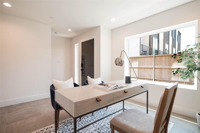 home office featuring recessed lighting, healthy amount of natural light, and baseboards