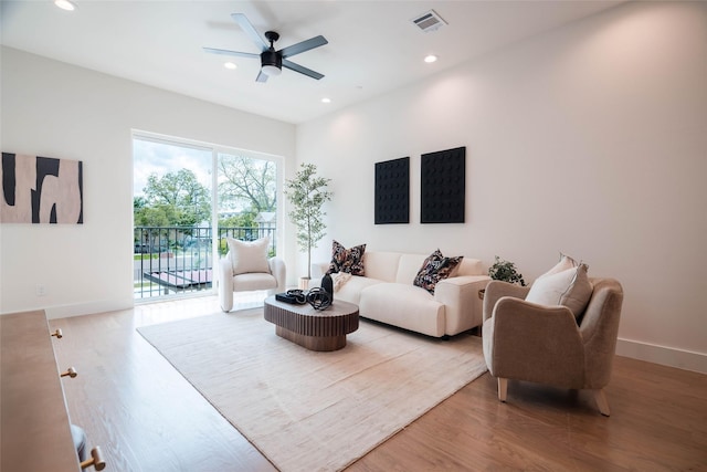 living area featuring wood finished floors, recessed lighting, ceiling fan, and baseboards