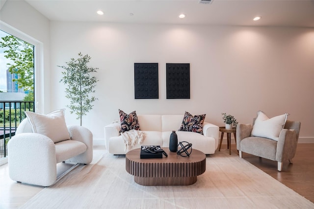living area with wood finished floors, recessed lighting, and baseboards