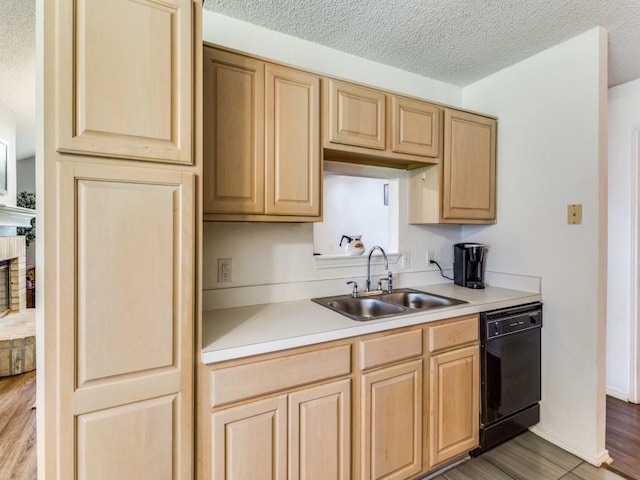 202 Lancelot Dr, Weatherford, TX 76086 - kitchen featuring black dishwasher, a sink, light brown cabinetry, light countertops, and a textured ceiling