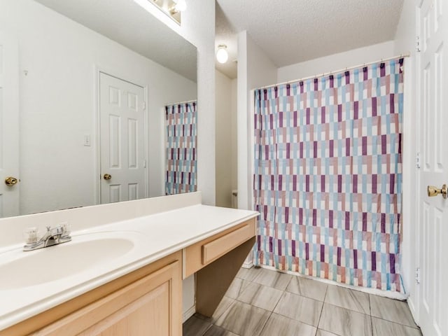 202 Lancelot Dr, Weatherford, TX 76086 - bathroom featuring vanity, a shower with curtain, and a textured ceiling