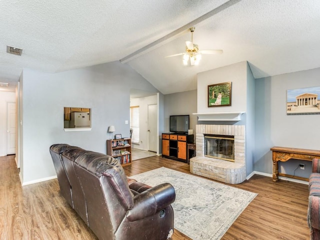 202 Lancelot Dr, Weatherford, TX 76086 - living room featuring a ceiling fan, wood finished floors, baseboards, and a textured ceiling