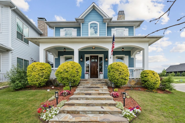 613 Park Place Blvd, Rockwall, TX 75087 - view of front of house featuring covered porch, a chimney, and a front yard