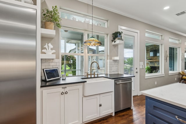 613 Park Place Blvd, Rockwall, TX 75087 - kitchen with open shelves, appliances with stainless steel finishes, backsplash, a sink, and ornamental molding