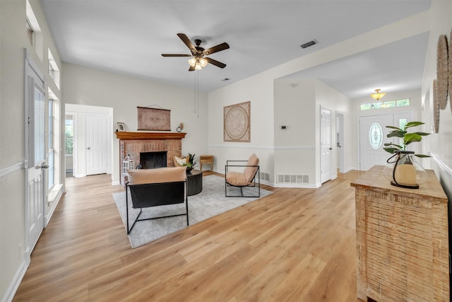 2802 Glen Ridge Dr, Arlington, TX 76016 - living room featuring light wood-style floors, ceiling fan, baseboards, and a fireplace