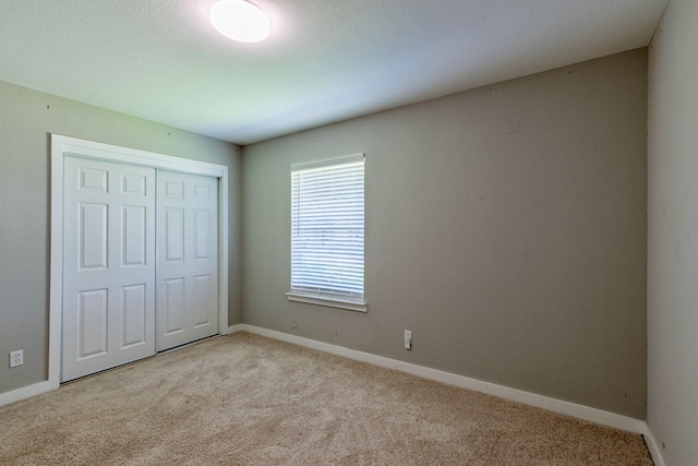 1708 Bardfield Ave, Garland, TX 75041 - unfurnished bedroom featuring carpet floors, a closet, and baseboards