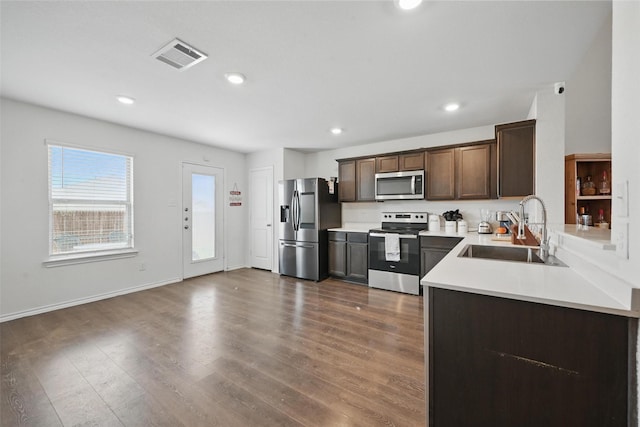 305 Sage St, Anna, TX 75409 - kitchen featuring appliances with stainless steel finishes, a sink, light countertops, dark wood-style floors, and dark brown cabinets