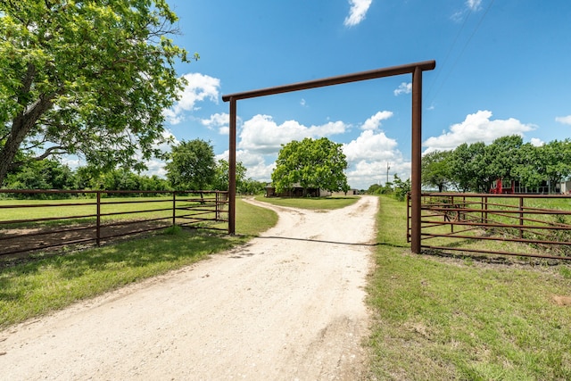 1545 County Road 130, Stephenville, TX 76401 - view of dirt / gravel driveway with a gated entry and a rural view