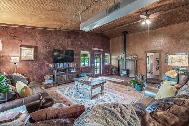 1545 County Road 130, Stephenville, TX 76401 - living area featuring a wood stove, ceiling fan, wood ceiling, wood finished floors, and high vaulted ceiling