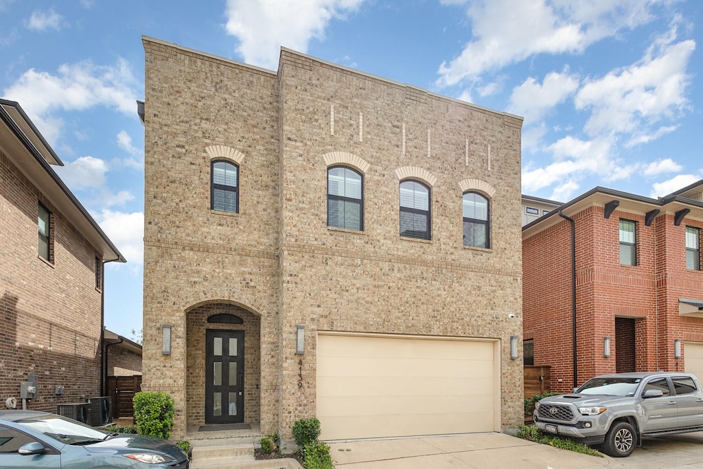 4139 Maison Rdg, Dallas, TX 75219 - view of front of home featuring an attached garage, driveway, and brick siding