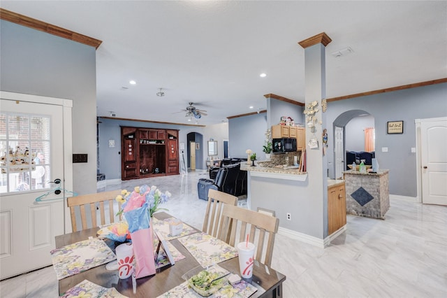 dining space featuring arched walkways, a ceiling fan, recessed lighting, crown molding, and baseboards