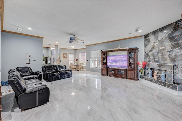 living area featuring ornamental molding, ceiling fan, marble tiled floors, a fireplace, and recessed lighting