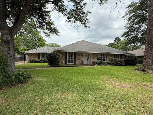 8309 Ashbourne Dr, Shreveport, LA 71106 - ranch-style home with a front lawn, a shingled roof, and brick siding
