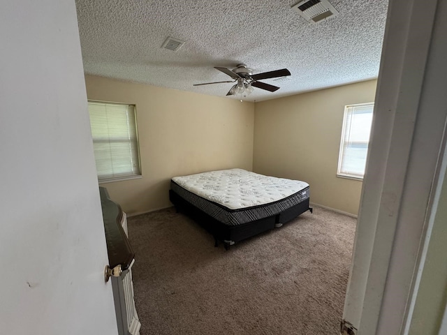 1946 US Highway 380 E, Graham, TX 76450 - carpeted bedroom with a textured ceiling and a ceiling fan