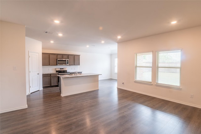 3929 Dickinson Ave, Aubrey, TX 76227 - kitchen with appliances with stainless steel finishes, open floor plan, a center island with sink, a sink, and recessed lighting