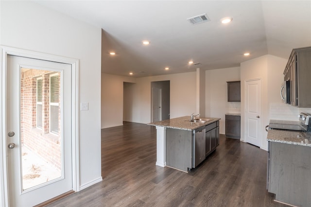 3929 Dickinson Ave, Aubrey, TX 76227 - kitchen featuring a sink, stainless steel appliances, dark wood-style flooring, a kitchen island with sink, and recessed lighting
