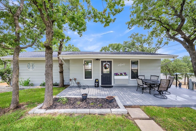 8 Tula Ct, Nocona, TX 76255 - back of property featuring outdoor dining space, a lawn, and a deck
