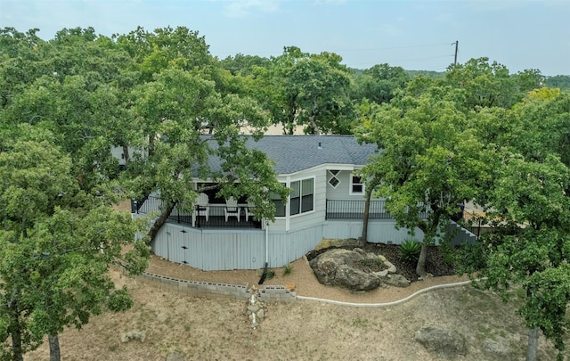 8 Tula Ct, Nocona, TX 76255 - back of property featuring a shingled roof and a wooden deck