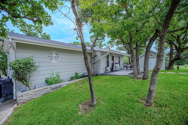 8 Tula Ct, Nocona, TX 76255 - view of front of home with a patio area, a front yard, and an outbuilding