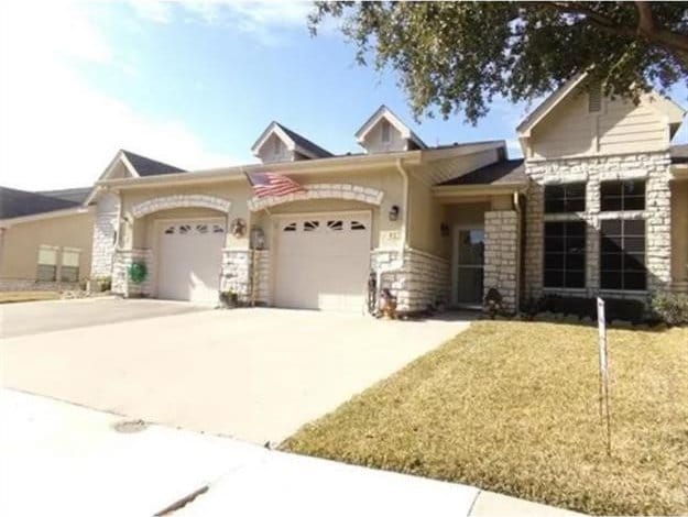 827 Kitty Hawk Ln, Grand Prairie, TX 75051 - view of front of house featuring a garage, concrete driveway, and stone siding