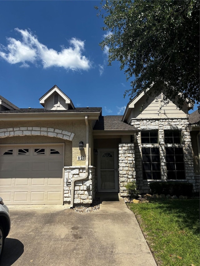 827 Kitty Hawk Ln, Grand Prairie, TX 75051 - view of front of home with stone siding, an attached garage, concrete driveway, a shingled roof, and a front lawn
