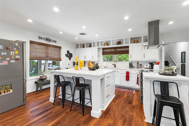 218 Rainbow Dr, Woodway, TX 76712 - kitchen with freestanding refrigerator, island range hood, a kitchen island, open shelves, and a kitchen bar
