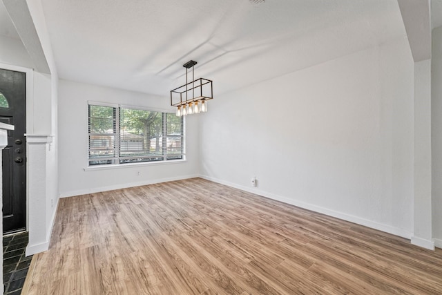 600 Circleview Dr N, Hurst, TX 76054 - unfurnished dining area featuring light wood-style flooring, baseboards, and a chandelier