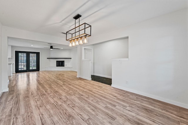 600 Circleview Dr N, Hurst, TX 76054 - unfurnished living room with wood finished floors, baseboards, and a glass covered fireplace