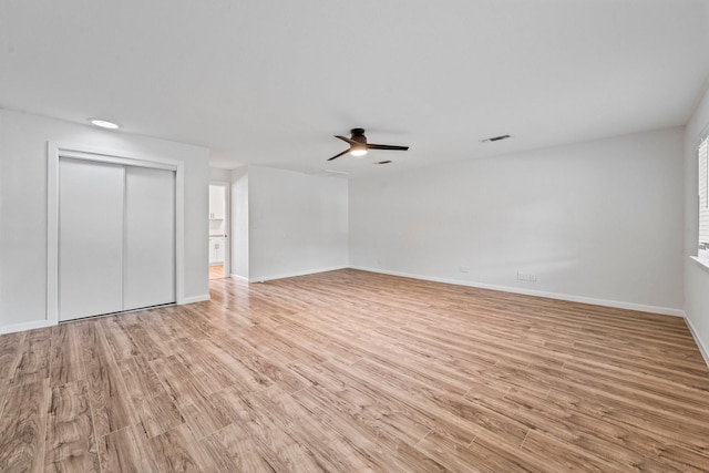600 Circleview Dr N, Hurst, TX 76054 - unfurnished living room featuring light wood-type flooring, a ceiling fan, and baseboards