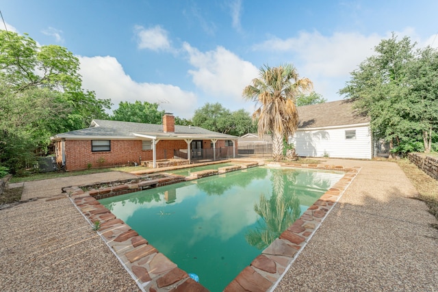 600 Circleview Dr N, Hurst, TX 76054 - view of swimming pool with fence, a patio area, and a pool with connected hot tub