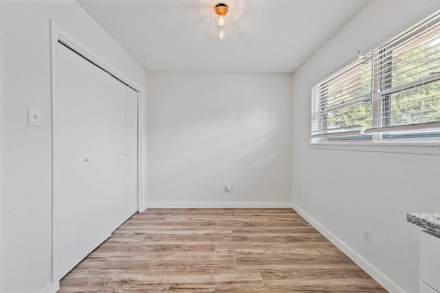 600 Circleview Dr N, Hurst, TX 76054 - unfurnished bedroom featuring light wood-style floors, a closet, and baseboards