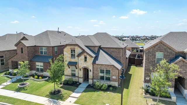 2825 Hale Rd, Celina, TX 75009 - french provincial home featuring stone siding, a residential view, a front lawn, and a shingled roof