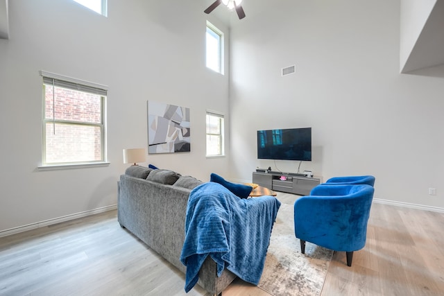 2825 Hale Rd, Celina, TX 75009 - living room with a high ceiling, ceiling fan, wood finished floors, and baseboards