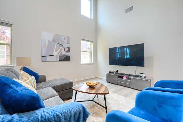 2825 Hale Rd, Celina, TX 75009 - living room featuring healthy amount of natural light, wood finished floors, baseboards, and a high ceiling