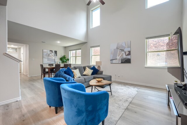 2825 Hale Rd, Celina, TX 75009 - living room with a towering ceiling, ceiling fan, light wood finished floors, and baseboards