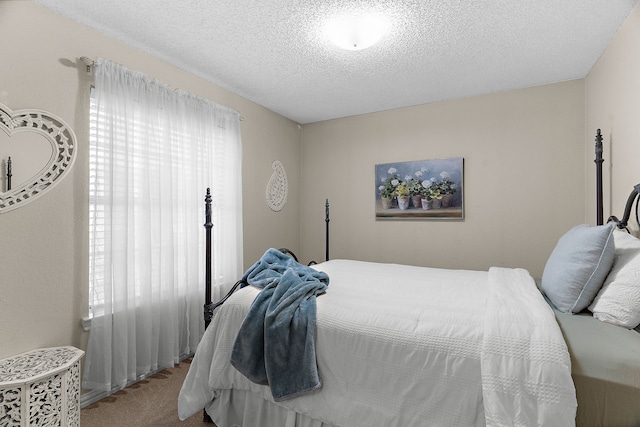 carpeted bedroom featuring a textured ceiling