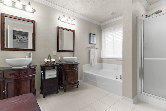 full bath with ornamental molding, a stall shower, a garden tub, a textured ceiling, and two vanities