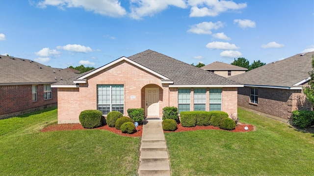 813 Canyon Pl, Desoto, TX 75115 - view of front facade featuring brick siding, a front yard, and a shingled roof