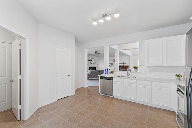813 Canyon Pl, Desoto, TX 75115 - kitchen featuring appliances with stainless steel finishes, a sink, ceiling fan, white cabinets, and light tile patterned flooring