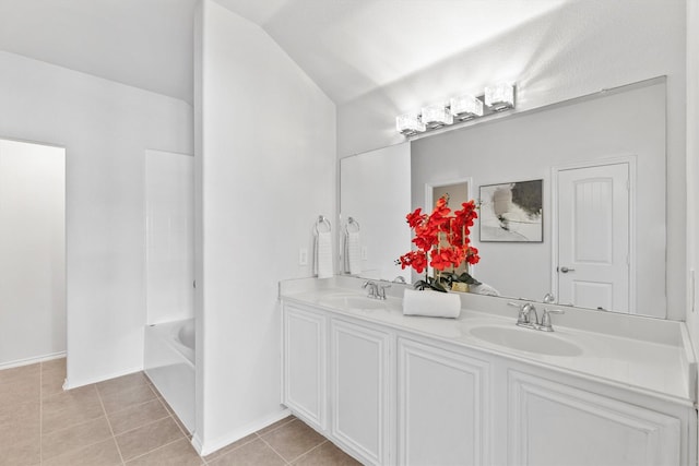 813 Canyon Pl, Desoto, TX 75115 - bathroom with tile patterned floors, double vanity, a tub, and vaulted ceiling