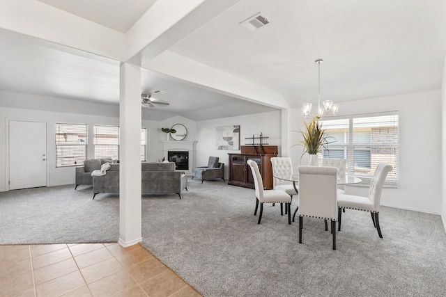 813 Canyon Pl, Desoto, TX 75115 - dining space with light colored carpet, a chandelier, a ceiling fan, a glass covered fireplace, and baseboards