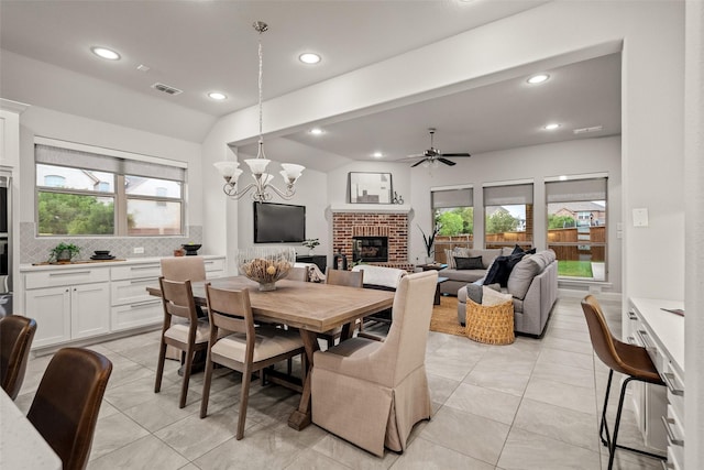 1429 Bridgewater Blvd, Celina, TX 75009 - dining space featuring a fireplace, a ceiling fan, recessed lighting, light tile patterned floors, and a chandelier