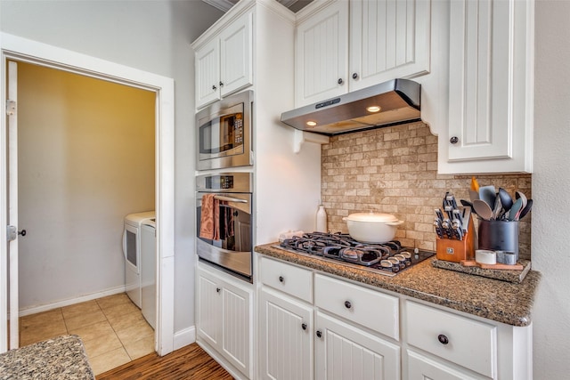 1009 W 7th St, Justin, TX 76247 - kitchen with appliances with stainless steel finishes, under cabinet range hood, tasteful backsplash, and white cabinets